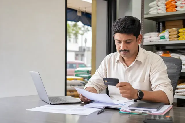 Indian consumer reviewing business credit card features and monthly spending