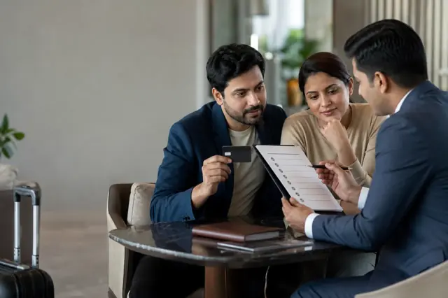 Indian consumer reviewing luxury credit card features and monthly spending
