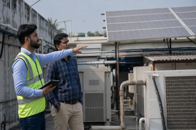 Indian business owner evaluating a clean-energy project and savings