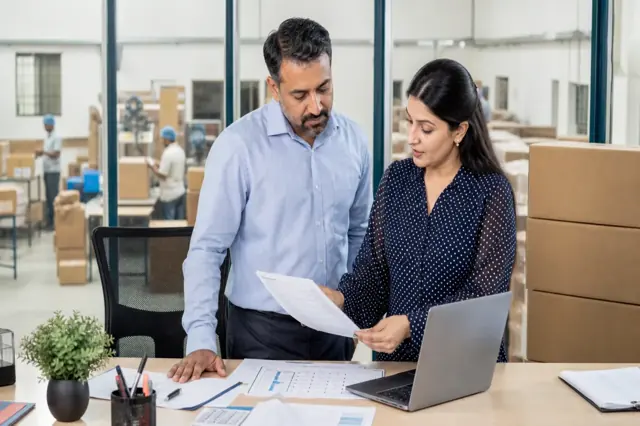 Indian business team reviewing unpaid invoices and receivables finance