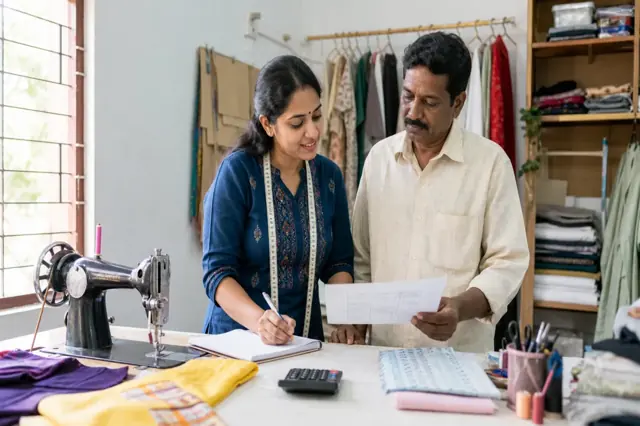 Indian micro-enterprise owner reviewing business project costs